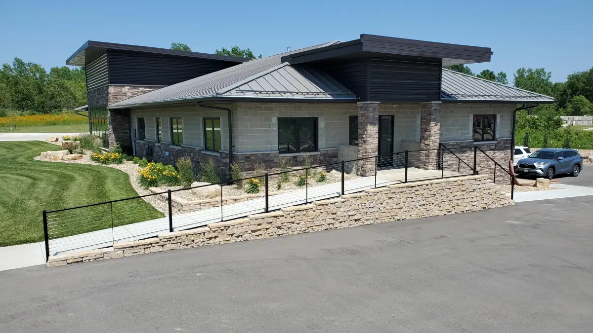 Commercial building with natural stone retaining wall and professional landscaping