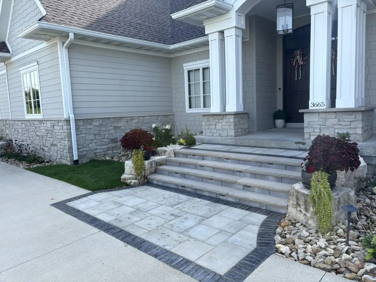 Designed front entrance with paver landing, Japanese maple, and container plantings