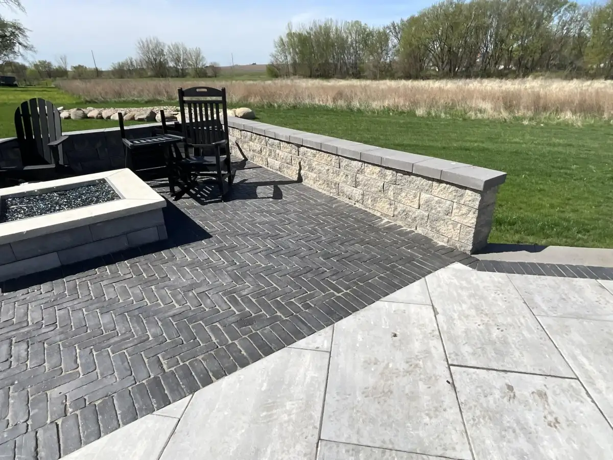 Rocking chairs around fire pit on herringbone paver patio