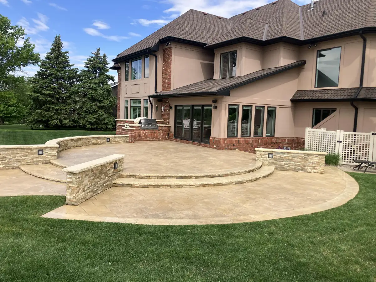 Grand curved stamped patio with stone fire pit