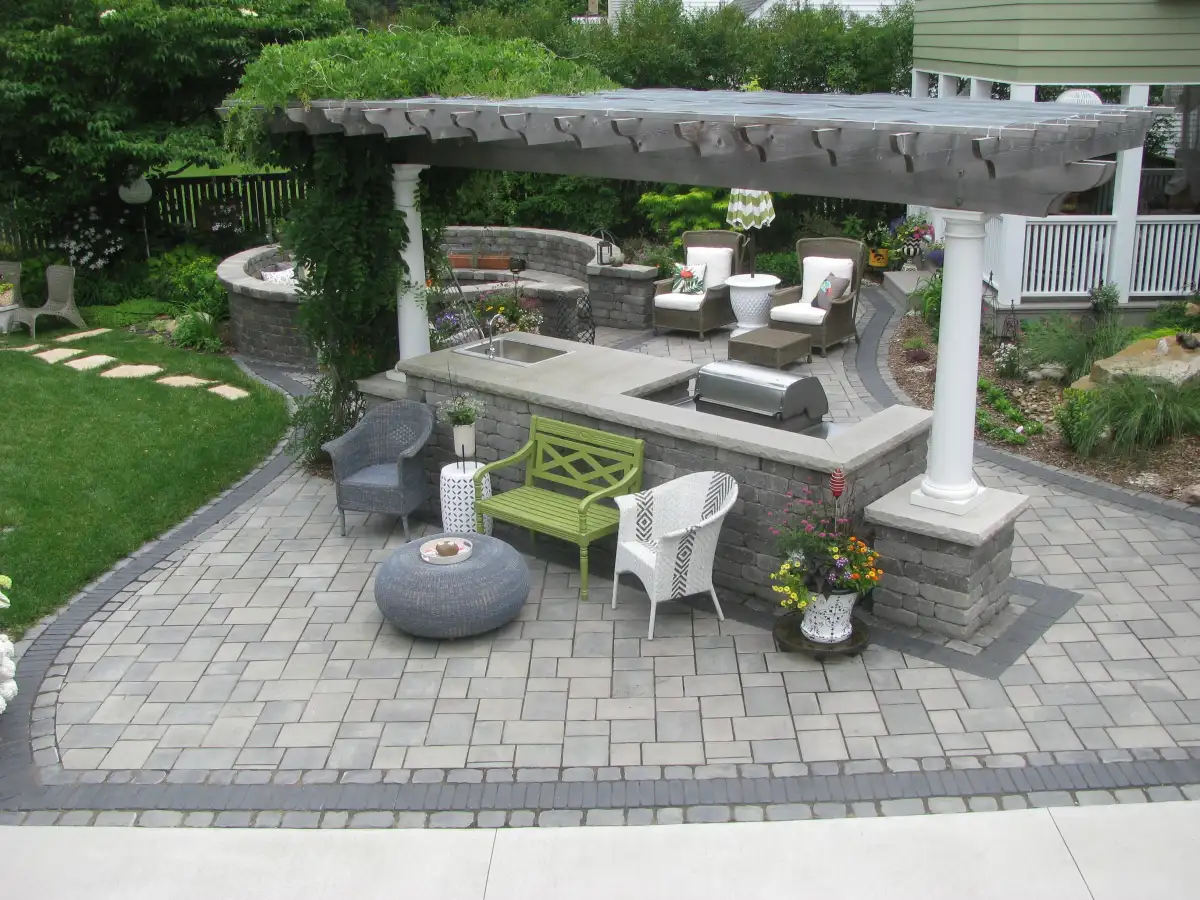 Outdoor kitchen island with stone veneer and built-in grill in Cedar Valley Iowa