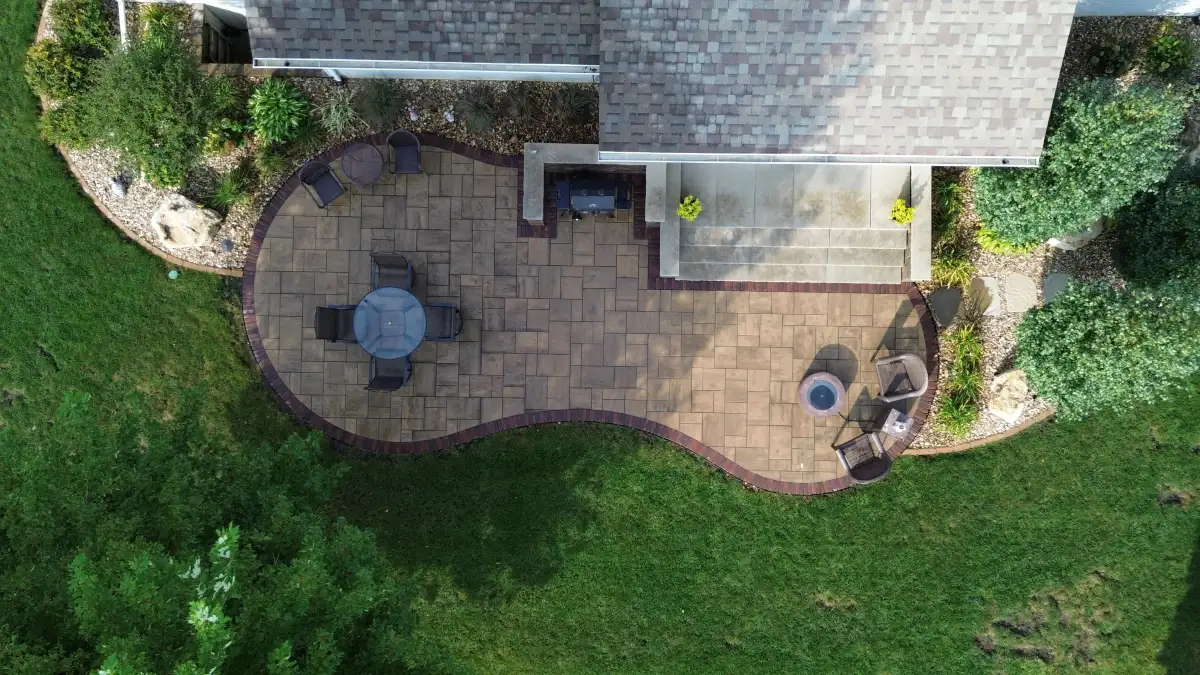 Aerial drone view of custom curved paver patio installation in Waterloo Iowa
